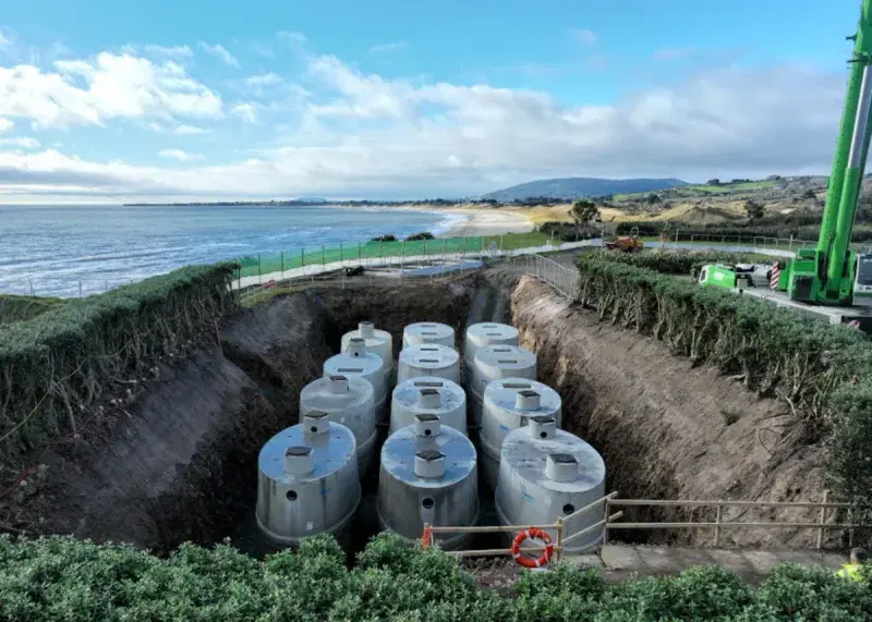 Aerial view of precast concrete tanks installed beside the coast